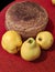 Home made bread and three Quince fruits on the red fabric