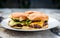 Home made burgers on a plate on stone paved terrace.