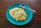 Home made Carbonara on blue plate with spoon and fork