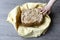 Home made cereal bread in yellow cloth on wooden table with child hand