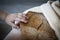 Home made cereal bread in yellow cloth on wooden table with child hand