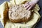 Home made cereal bread in yellow cloth on wooden table with child hand