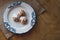 Home made choux cream on white plate. Over on wood table. Top view. with a white glaze. on wooden background