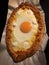 Home made diet proper nutrition khachapuri - traditional Georgian pie with cheese and egg. Horizontal image