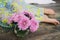 Home made floral decoration on a dark background. Beautiful chrysanthemum in a vase. Purple chrysanthemum, pink flowers on a shelf