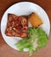 Home made pizza on square sliced bread with grilled Corn and lettuce in the white round plate on the wooden table.