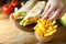 Home made shawarma. French fries and shawarma on the rustic wooden table. Hand taking a fried potato.