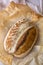 Home made Sour dough Artisan Spelt Bread after baking in a dutch oven on marble background.