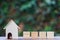 Home model and four empty wooden square block or cube on wood table