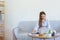 Home office concept, Businesswoman reads marketing plan data on laptop and taking notes on notebook