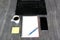 Home office laptop, cell phone, notepad pen, coffee apple