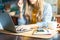 Home office woman and distance learning online education. Cropped beautiful lady girl working at notebook in kitchen and drinking