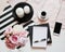 Home office workspace. Notebook with copyspace. Beauty blog. Woman fashion accessories, phone and coffee on white bed background.