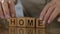 Home, old man making word of wooden cubes, missing home, motherland, close-up