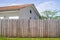 Home palisade wooden fence to hide the neighbor from house