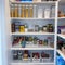 A home pantry that is organized with various products in put away in a tidy manner