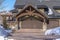 Home in Park City Utah in winter with gabled garage entrance against blue sky