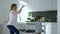 Home party, mum with kid cheerfully dancing in apartment in kitchen