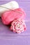 Home pink and white crochet rose two skeins of cotton yarn and crochet hook on lilac wooden background