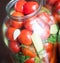 Home preservation. Ripe red tomatoes in the process of canning.