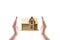 Home protection concept, close up of female hands sheltering modern house,Small wooden house covered by hands
