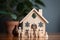 Home protection Wooden family model shielded by house icon symbolizes insurance
