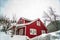 Home with red walls and front porch on a snowy mountain in Park City Utah