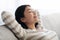 Home Relax. Portrait Of Calm Asian Woman Resting On Sofa With Closed Eyes