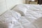Home relaxation nconcept : empty white rumpled bed sheet in morn