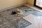 Home renovation of ceramic tiles in an entrance way. Breaking up the tiles DIY and cleaning up broken pieces before laying new