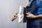 Home repair: a girl in a denim suit smears putty on a spatula.