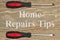 Home Repairs Tips message with screwdrivers on weathered wood