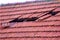 Home roof damage after storm. fallen shingles on house