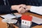 Home sales agents and buyers work on signing new homes and shaking hands