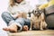 Home daily scene with people and dog with woman sit down on the floor hug an old pug dog - concept of friendship forever with best