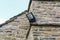 Home security light mounted on the corner of a rural stone cottage.