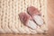 Home slippers made of fur on the background of white merino wool plaid. The atmosphere of homeliness and comfort