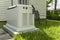 A Home Standby Generator installed at the backyard of a house. An air-cooled natural gas or liquid propane generator for