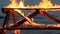 Home style video. No sound. Slats falling down thirty 30 seconds. Extreme close-up video of a burning picnic table.