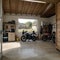Home suburban countryside modern car and ATV double garage interior with wooden shelf, tools and equipment stuff storage warehouse