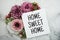 Home Sweet Home text with pink flower bouquet on marble background