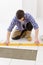 Home tile improvement - handyman with level