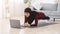 Home Trainings. Fit muslim woman doing yoga plank in front of laptop