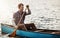 Home is on the water. a young man kayaking on a lake outdoors.