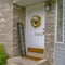 Home with white front door and welcome sign board