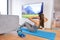 Home workout - woman exercising in front of TV