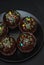 Homebaked Chocolate Muffins for Easter with colored Conffeti. Dark Background. Sweet Dessert for Breakfast.