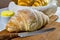 Homebread. Home made bread on wooden cutting board with knife and porcelain ramekin with butter on the side