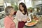 Homecare assistant helps cooking for an elderly woman