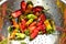 Homegrown red, orange, and green small hot chili peppers spicy vegetable ingredient for cooking
